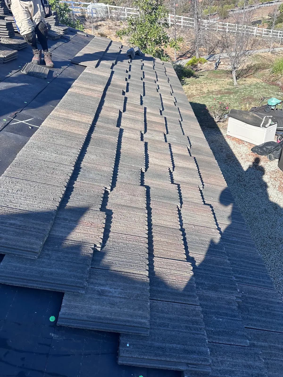 Rows of roof tiles being set over roofing underlayment